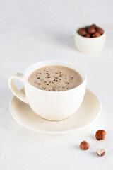 Obraz na płótnie Canvas Hazelnut mochaccino coffee with coconut milk in a cup.