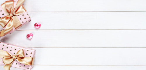 Banner. Valentines Day. Flat lay of gift boxes and hearts on white wooden background. Copy space. Concept of holidays and love.