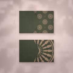 Presentable business card in green color with a mandala pattern in brown for your personality.