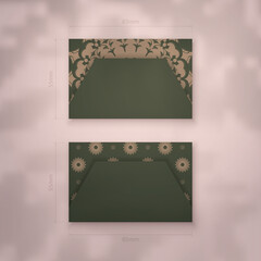 Presentable business card in green color with abstract brown ornament for your contacts.
