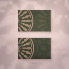 Presentable business card in green with a mandala in brown pattern for your brand.