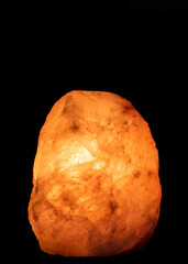 Salt lamp glowing in the darkness