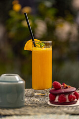 Orange juice with a blurred cake