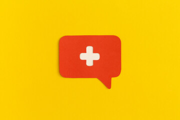 Medicine cross on a yellow background. Health and medical treatment concept.