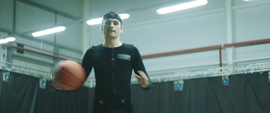 Pro basketball player in motion capture suit posing during the mocap shot. Motion capture is an unparalleled method for making animated characters move more realistically