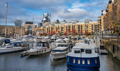  Luxury residential buildings and vintage sailing ships moored at St Katherine Dock, London. 