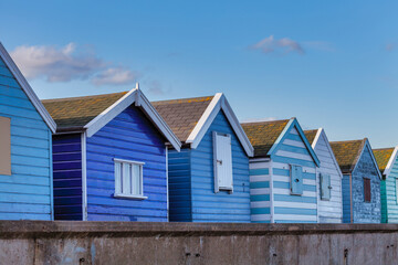 Fototapeta na wymiar Traditional Beach Huts On British Shore