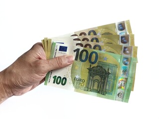 Human hand holding several  euro banknotes on a white background.