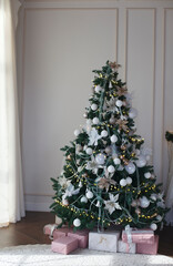 Christmas, xmas, New Year interior: а fir tree and bear toy on the bed