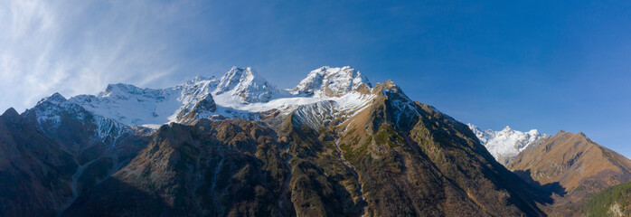 Scenic autumn mountain landscape with snow peaks, Tuymazinsky glacier, Digor Gorge, Northern Ossetia, Caucasus, Russia