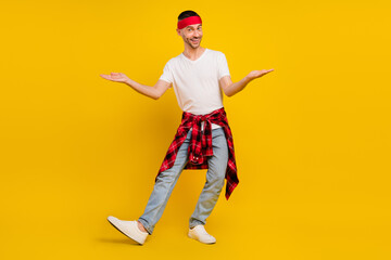 Full length photo of happy man wear plaid shirt on waist hands scales empty space isolated on yellow color background