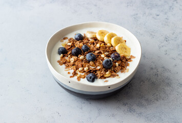 Granola with yogurt, blueberries, nuts, banana and honey. Muesli. Healthy eating. Vegetarian food.