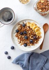 Granola with yogurt, blueberries, nuts, banana and honey. Muesli. Healthy eating. Vegetarian food.