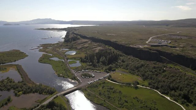 Cinematic aerial footage of Thingvellir national park, Iceland's parliament, the Thingvellir Church and the ruins of old stone shelters, hikes and lake in the golden circule