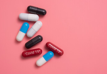 COVID-19 medicine, medicine for COVID-19, Capsule medicine, capsules pills,various capsule on a pink background