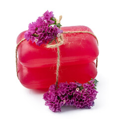 Bars of handmade natural soap and flowers on white background