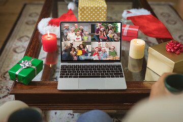 Four happy diverse families at christmas smiling on laptop group video call screen