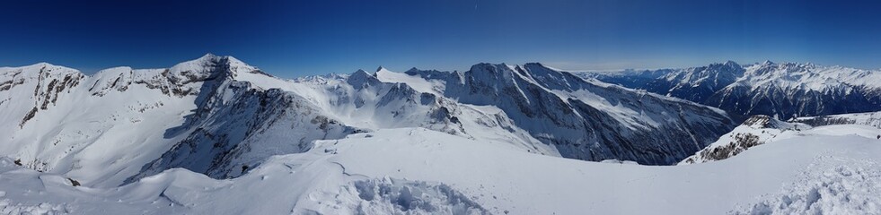 A beautiful and serene landscape of mountains covered with snow. Thick snow covers the slopes....