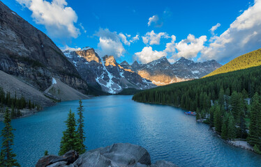 Beautiful turquoise waters of the Moraine Lake with snow-covered peaks above it in Rocky Mountains, Banff National Park, Canada.	