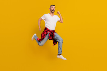 Fototapeta na wymiar Full length body size photo man jumping up running on shopping sale isolated vivid yellow color background