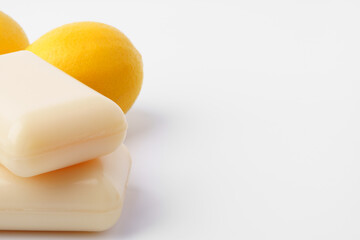 Handmade citrus soap and fresh fruit on white background