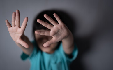 Young girl making stop gesture with her hand,Stop violence and abuse children. human trafficking concept.