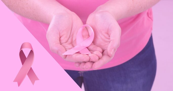 Composite image of woman with breast cancer awareness ribbon