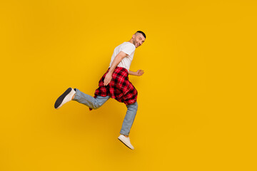 Fototapeta na wymiar Full length body size photo man jumping running on sale isolated bright yellow color background