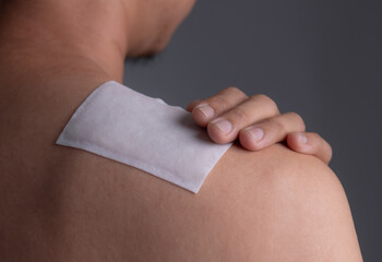 Medicated pain relief patch with man pain shoulders,office syndrome,Health problems from overworked concept.