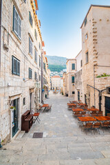 Table near the restaurants at Dubrovnik old town square. Summer morning after sunrise. Ancient town in Croatia.