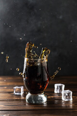 splashing sweet cola in a glass