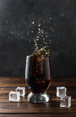 splashing sweet cola in a glass