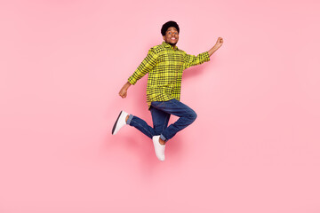 Full length photo of happy man jump up empty space amazed isolated on pink color background