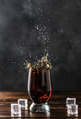 splashing sweet cola in a glass