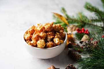Caramel popcorn on holiday Xmas background, selective focus
