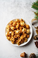 Caramel popcorn on holiday Xmas background, selective focus