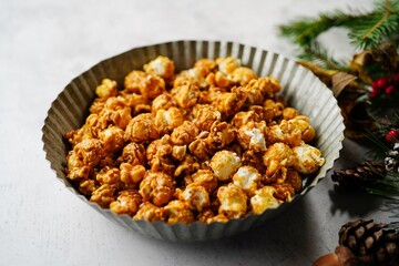 Caramel popcorn on holiday Xmas background, selective focus