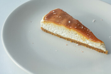 A slice of cheese cake with salted caramel