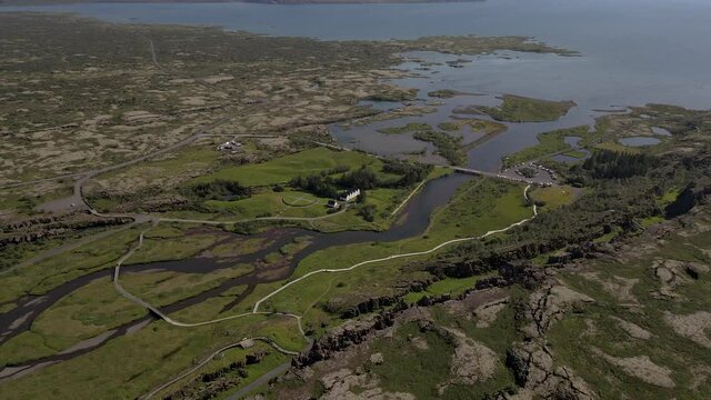 Cinematic aerial footage of Thingvellir national park, Iceland's parliament, the Thingvellir Church and the ruins of old stone shelters, hikes and lake in the golden circule