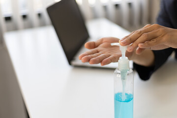 Hand disinfecting devices at office for prevent disease by sanitizing keyboard, corona virus or Covid-19 protection.