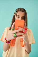 Portrait of little social networks addicted girl holding mobile phone