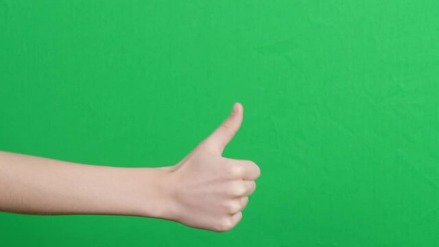 Like dislike gestures. Hand showing thumbs up, like, ok sign and change to thumbs down, dislike or negative sign symbol over green screen chroma key background