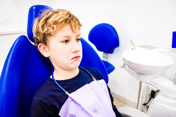 Annual visit to the dentist of a child with a strange face.