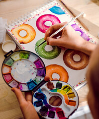 Hand painting colourful doughnuts in water colour 