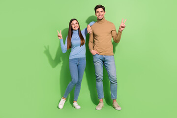 Fototapeta premium Photo of two funny friends spend free-time make v-sign wear casual outfit isolated green color background