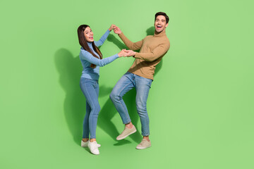 Photo of couple in love hold hands have carefree weekend fun wear casual outfit isolated green color background