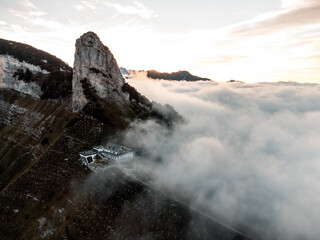 Drone shot of a foggy mountain from a bird view 