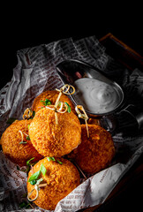 Fried Mozzarella Cheese Balls with Sauce on dark wooden background