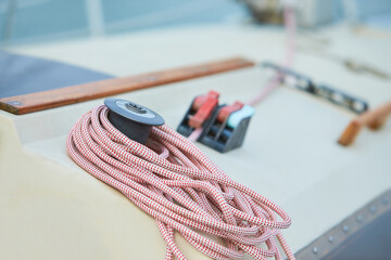 Winch and nautical ropes on a sailing boat in the port