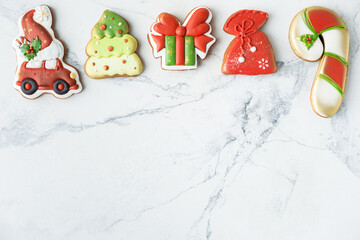 Flat lay of Christmas gingerbread cookies with festive icing and Christmas decoration on the white background. Merry Christmas and Happy New Year.